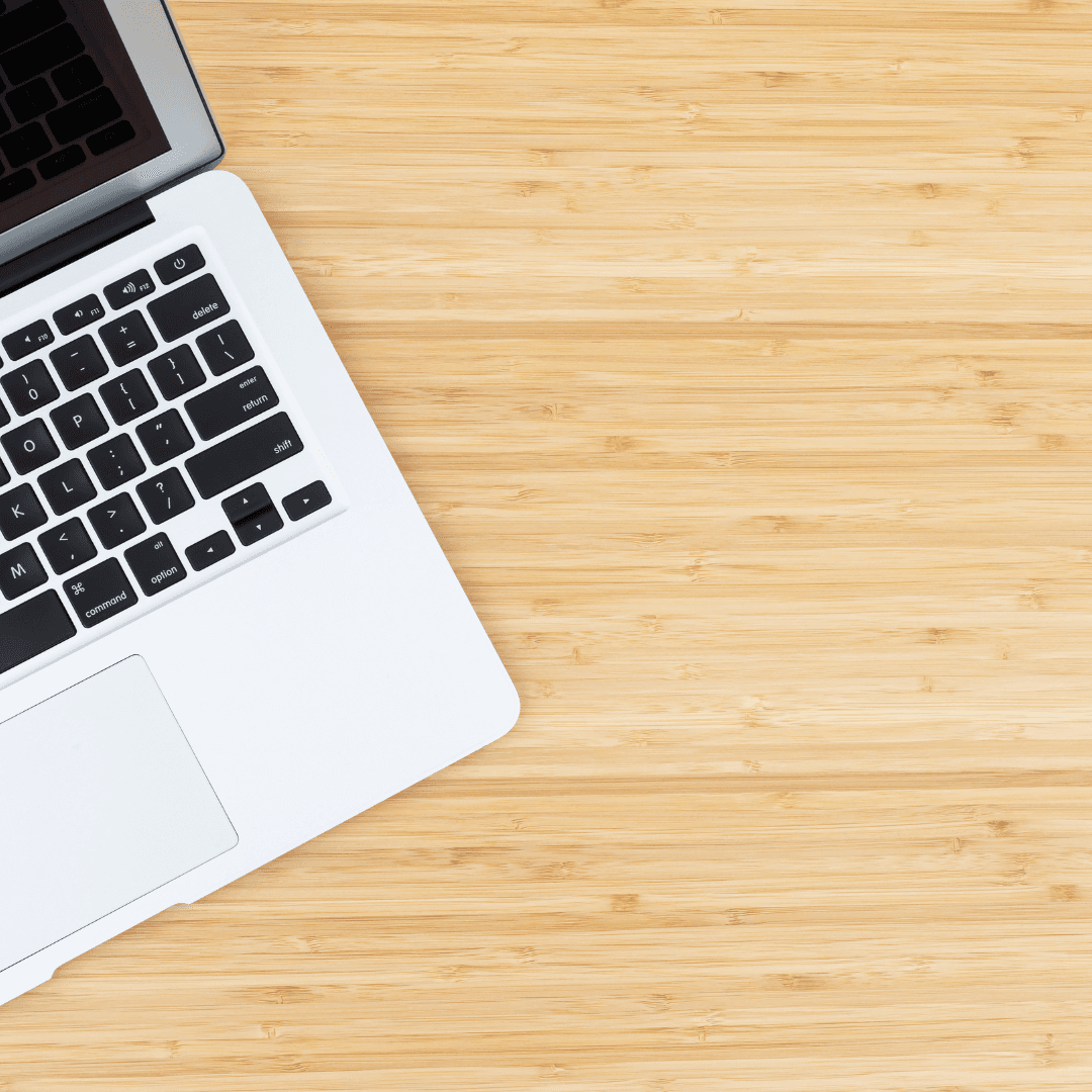 A laptop open on a wooden desk